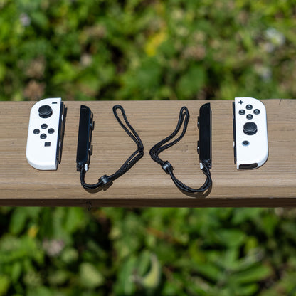 White Nintendo Switch Joy-Con L and R wireless controller pair with wrist straps