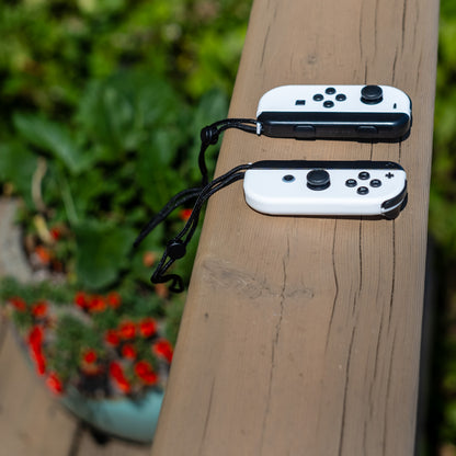 White Nintendo Switch Joy-Con L and R wireless controller pair with wrist straps