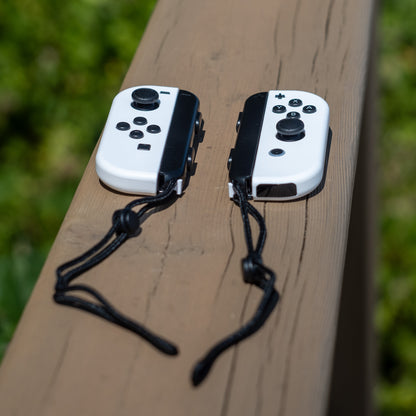 White Nintendo Switch Joy-Con L and R wireless controller pair with wrist straps