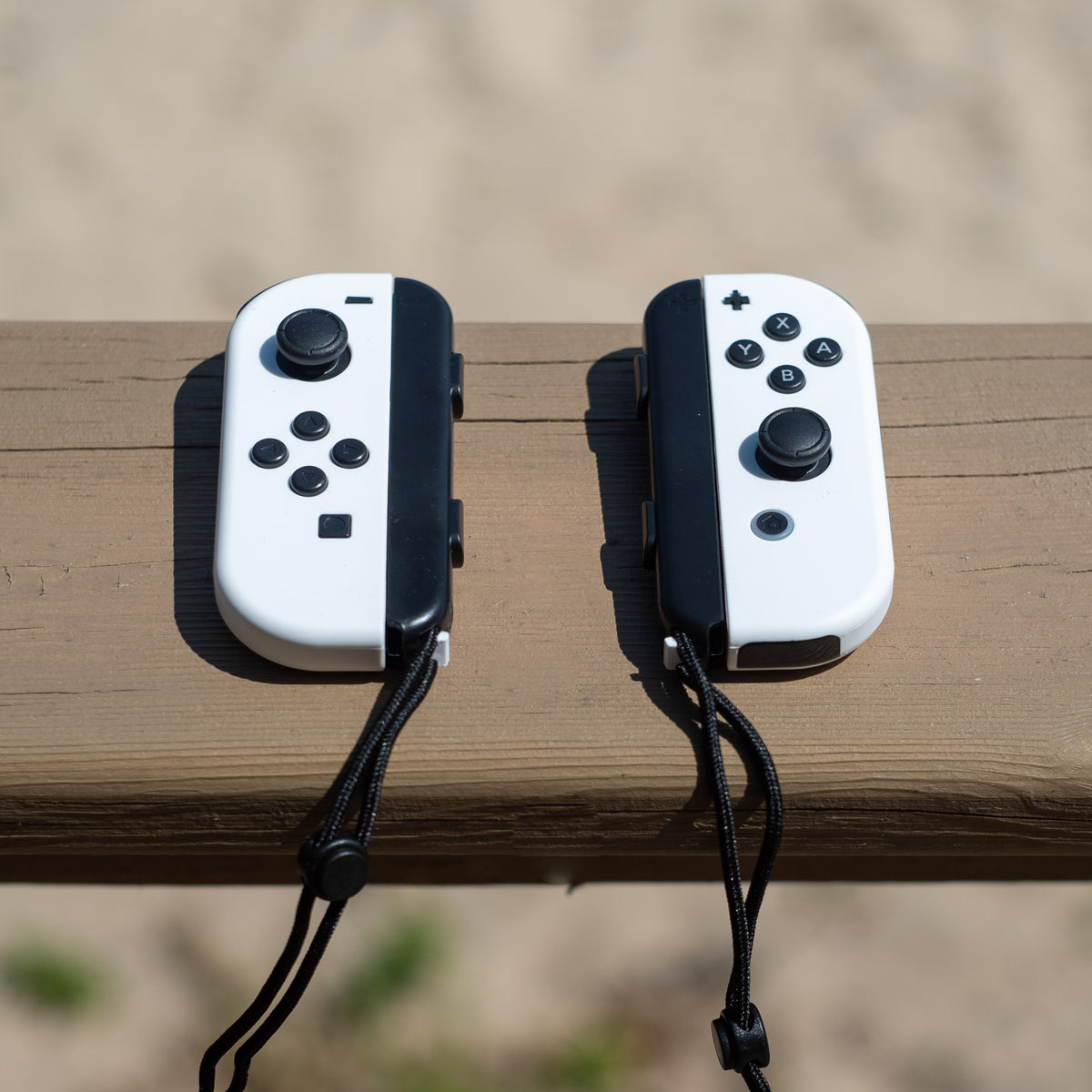 White Nintendo Switch Joy-Con L and R wireless controller pair with wrist straps