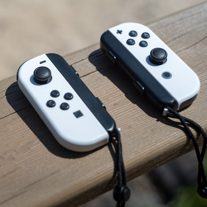 White Nintendo Switch Joy-Con L and R wireless controller pair with wrist straps