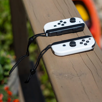 White Nintendo Switch Joy-Con L and R wireless controller pair with wrist straps