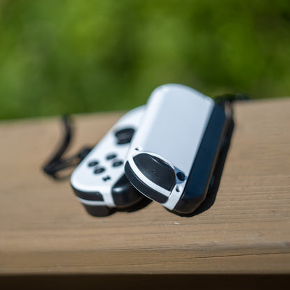 White Nintendo Switch Joy-Con L and R wireless controller pair with wrist straps