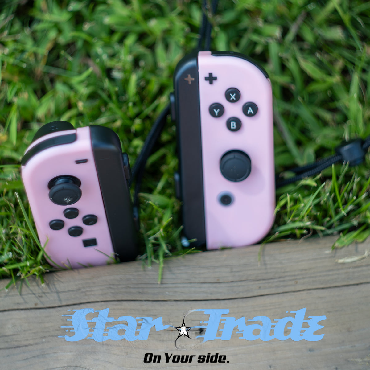 Pastel pink Nintendo Switch Joy-Con L and R wireless controller pair with wrist straps